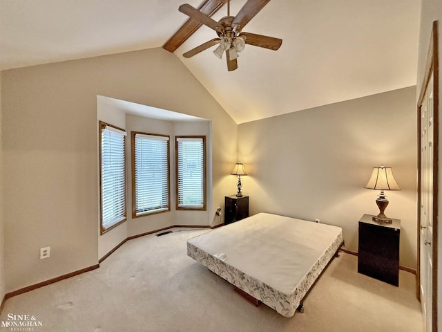 bedroom with lofted ceiling with beams, light carpet, and ceiling fan