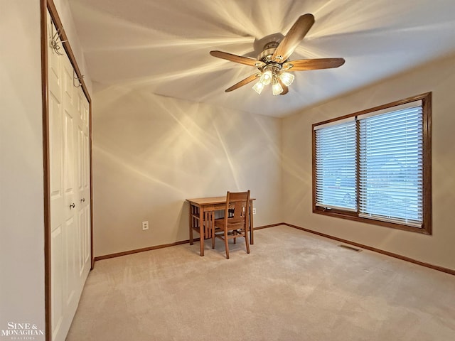 interior space with ceiling fan and light carpet