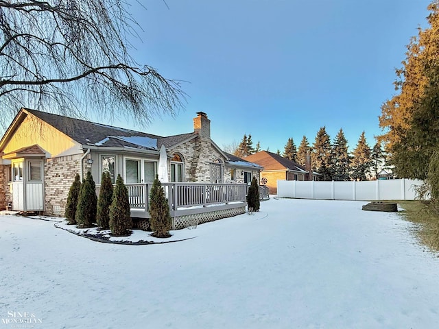 view of snow covered exterior featuring a wooden deck