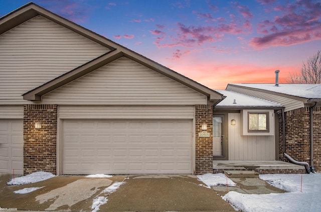 ranch-style home with an attached garage and brick siding