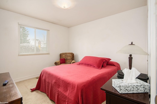 bedroom featuring baseboards and carpet