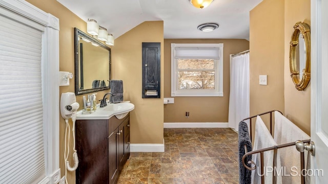 bathroom featuring vanity and lofted ceiling