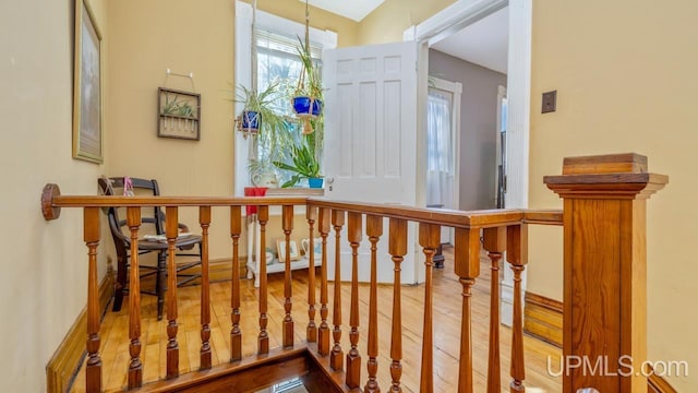 stairs with hardwood / wood-style flooring