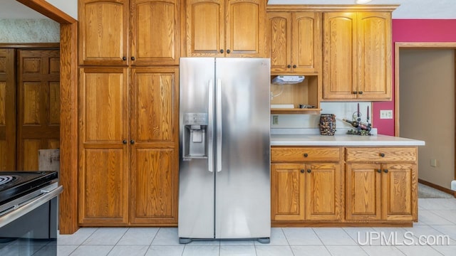 kitchen featuring stainless steel refrigerator with ice dispenser and light tile patterned floors