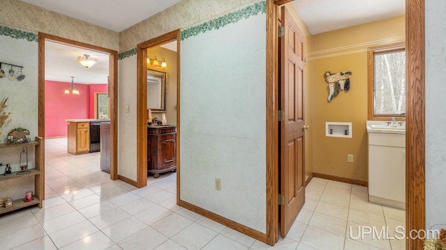 hallway with sink and light tile patterned floors