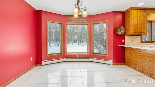 unfurnished dining area featuring light tile patterned floors, a baseboard radiator, and a chandelier