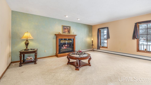 sitting room with baseboard heating and carpet flooring