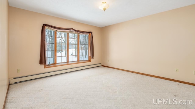 carpeted spare room with a baseboard radiator