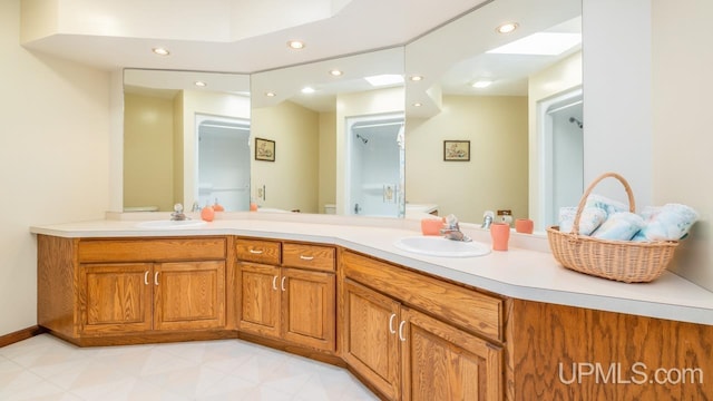 bathroom with vanity, a skylight, and toilet