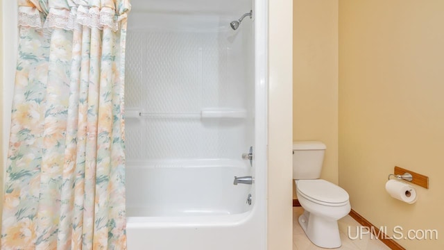 bathroom with tile patterned floors, toilet, and shower / bath combo