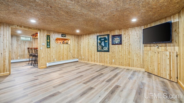 interior space with hardwood / wood-style flooring and baseboard heating