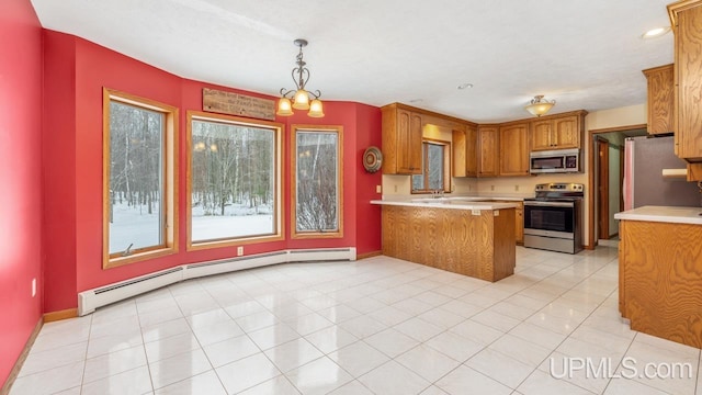 kitchen with light tile patterned flooring, kitchen peninsula, pendant lighting, stainless steel appliances, and a baseboard heating unit