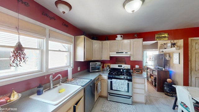 kitchen featuring sink, stainless steel gas range, hanging light fixtures, and black dishwasher