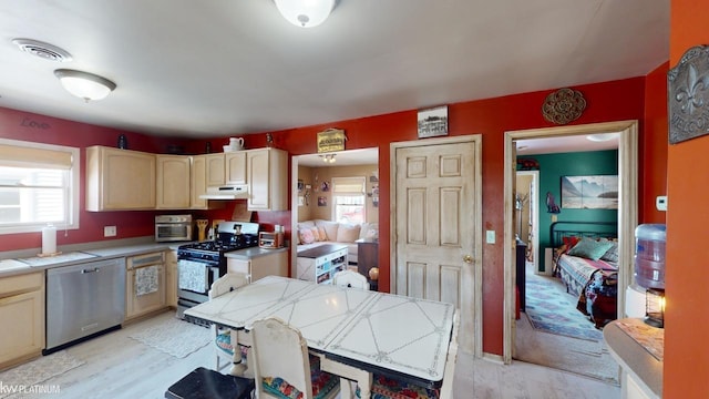 kitchen featuring appliances with stainless steel finishes, light brown cabinets, and light hardwood / wood-style flooring