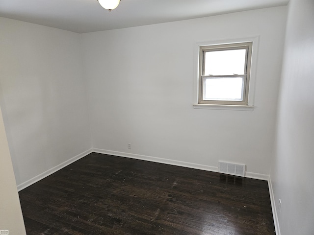 unfurnished room featuring dark wood-type flooring