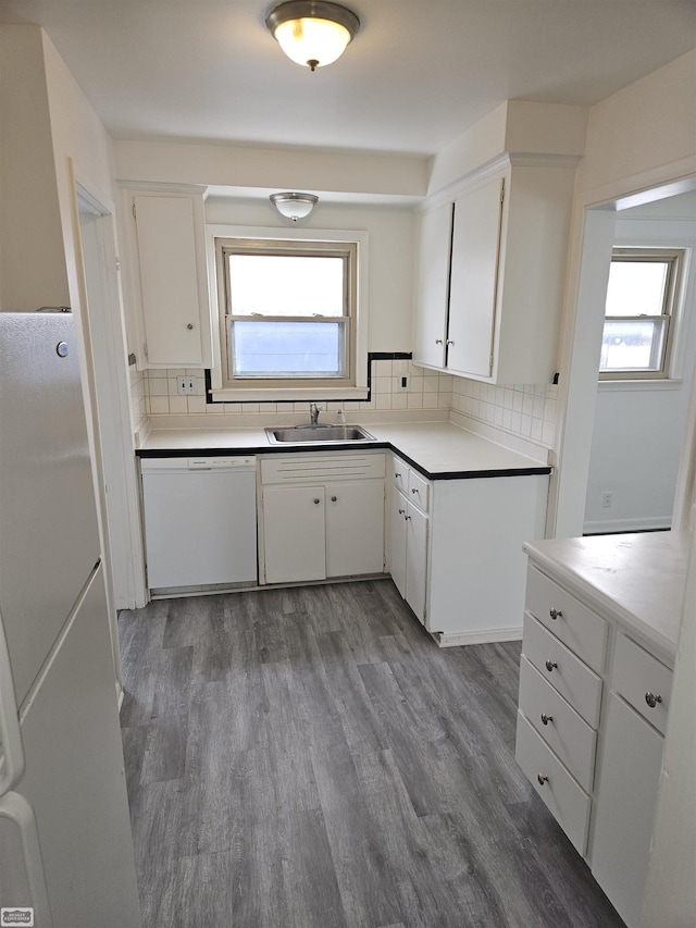 kitchen featuring white cabinetry, white appliances, and sink