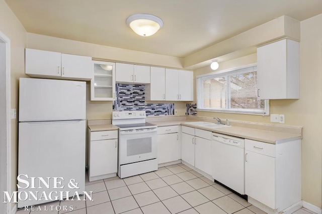 kitchen with sink, white cabinets, white appliances, and decorative backsplash