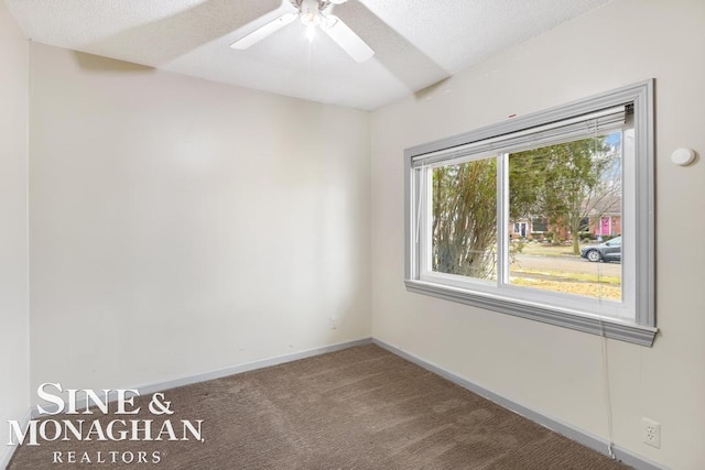 carpeted empty room with a textured ceiling and ceiling fan