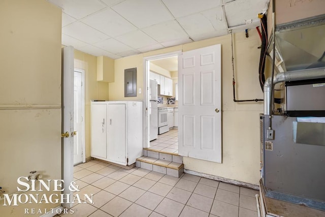 kitchen featuring light tile patterned floors, electric panel, and a drop ceiling