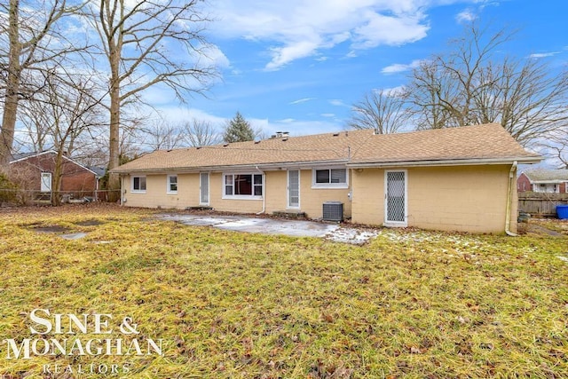 back of house featuring a yard, central AC unit, and a patio area