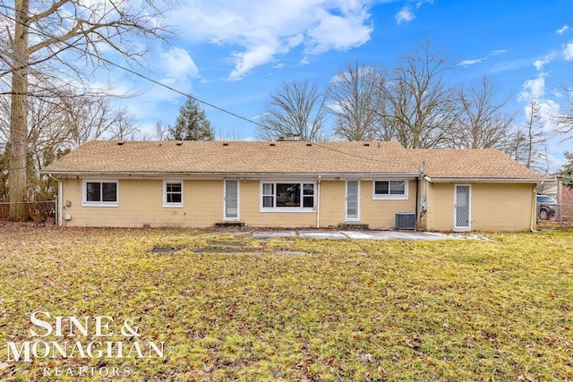 back of property featuring central AC unit, a lawn, and a patio