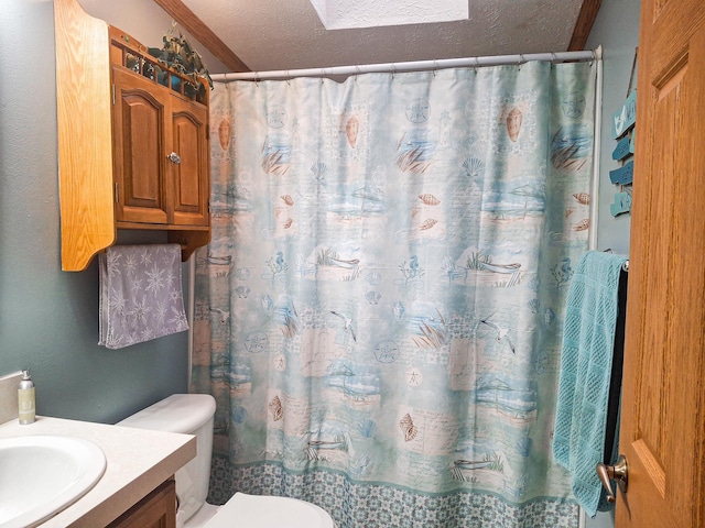 bathroom with vanity, curtained shower, a textured ceiling, and toilet