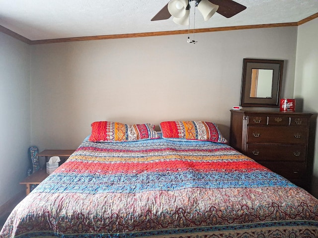 bedroom with ceiling fan, ornamental molding, and a textured ceiling