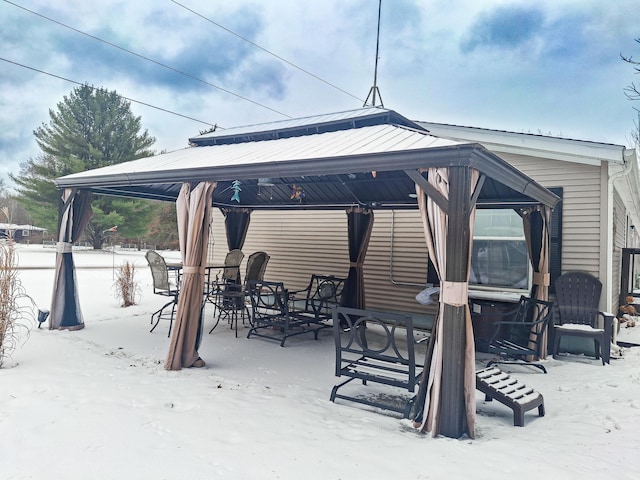 snow covered patio with a gazebo