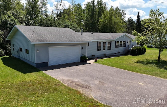 single story home featuring a garage and a front lawn