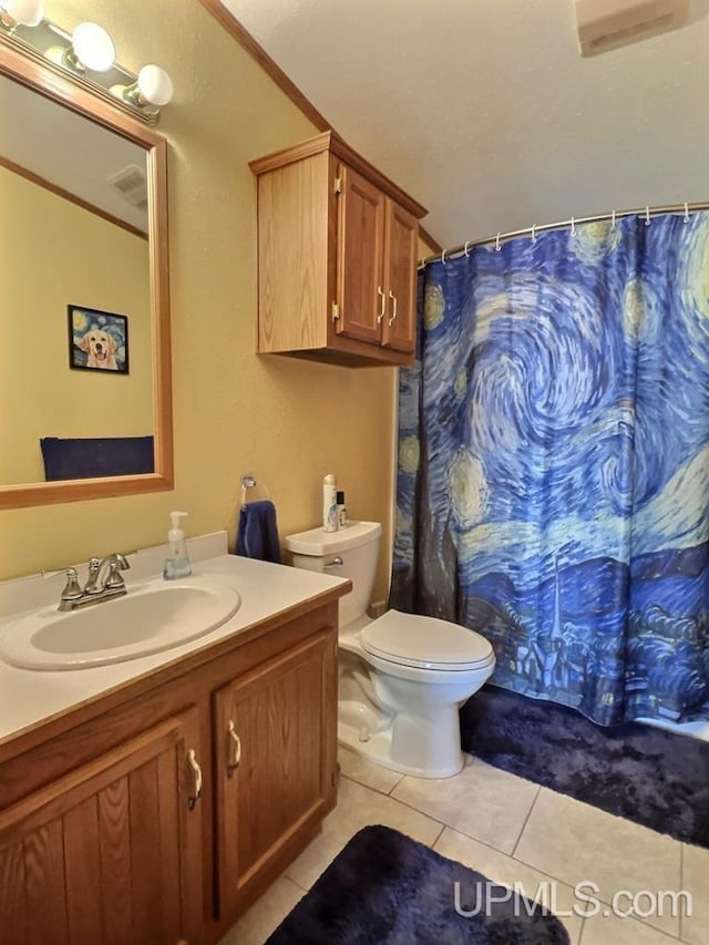 bathroom featuring crown molding, tile patterned flooring, vanity, toilet, and walk in shower