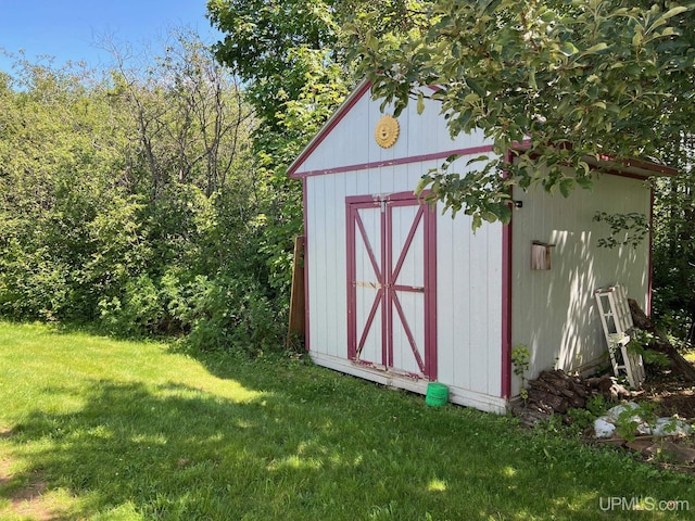 view of outbuilding featuring a yard