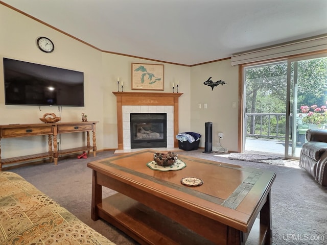 living room with crown molding, a fireplace, and dark carpet