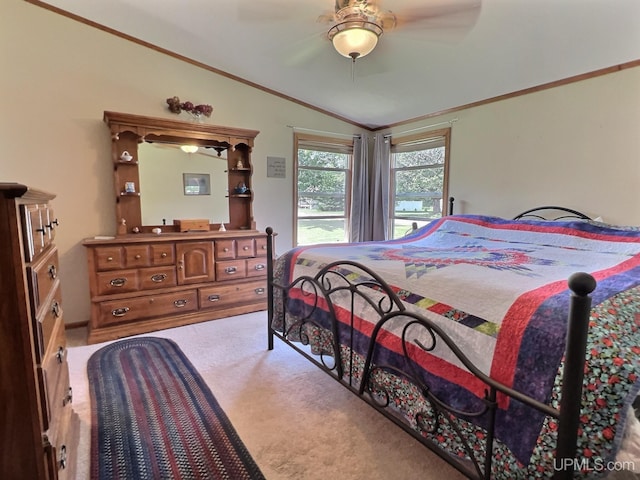 carpeted bedroom featuring ceiling fan, ornamental molding, and vaulted ceiling