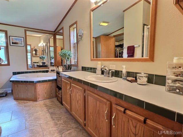 bathroom with independent shower and bath, ornamental molding, and vanity