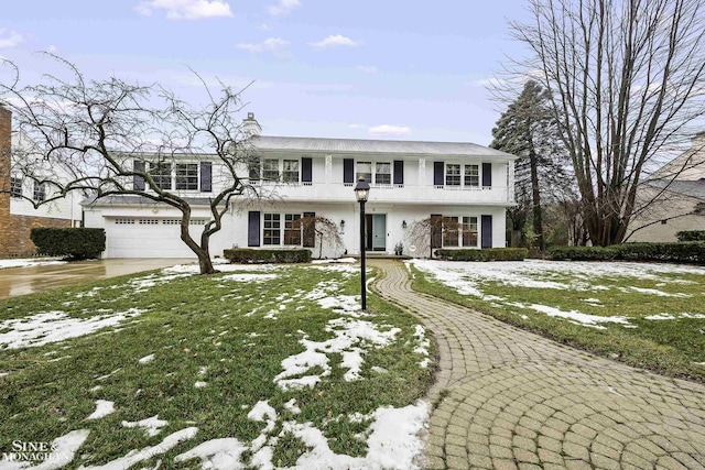 view of front property with a garage and a lawn