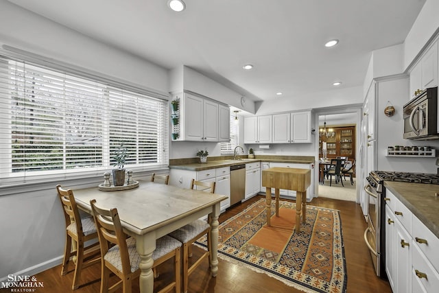 kitchen with dark hardwood / wood-style flooring, sink, white cabinets, and appliances with stainless steel finishes