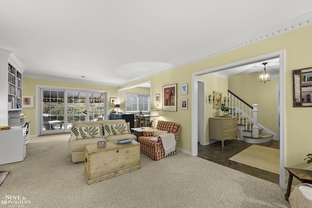 living room with ornamental molding, carpet, and a chandelier