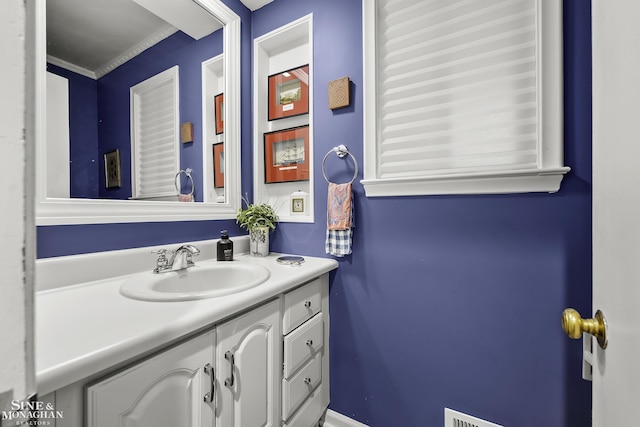 bathroom featuring vanity and crown molding