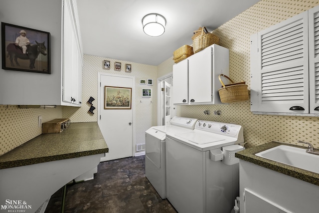 laundry area with cabinets, washer and clothes dryer, and sink