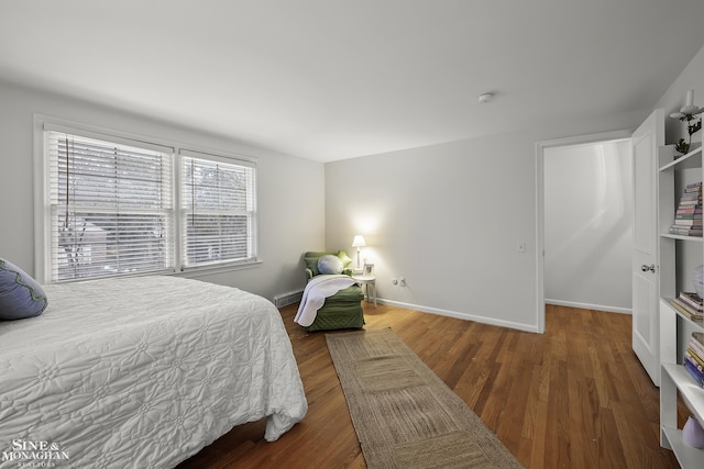 bedroom with dark hardwood / wood-style flooring