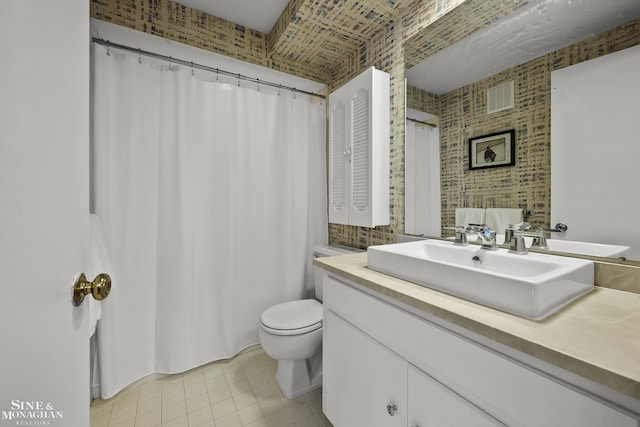 bathroom featuring vanity, tile patterned flooring, and toilet