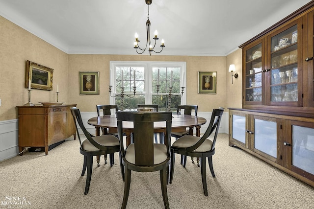 dining area featuring light colored carpet and an inviting chandelier