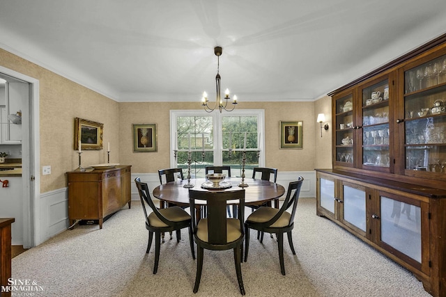 dining room featuring light carpet and a notable chandelier