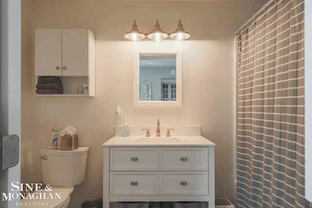 bathroom featuring vanity and toilet