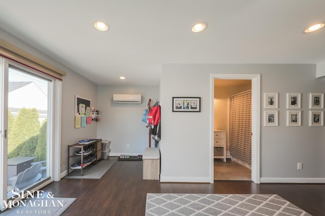 interior space featuring dark wood-type flooring and an AC wall unit