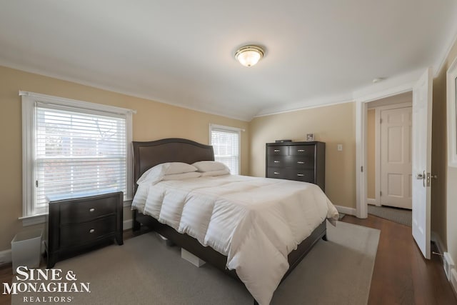 bedroom featuring hardwood / wood-style flooring and vaulted ceiling