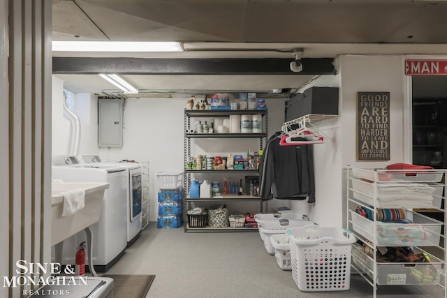 washroom with sink, washer and clothes dryer, and electric panel