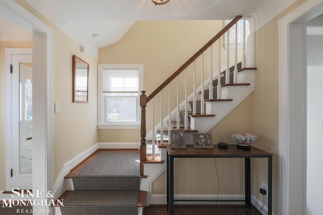 stairs with hardwood / wood-style flooring and lofted ceiling