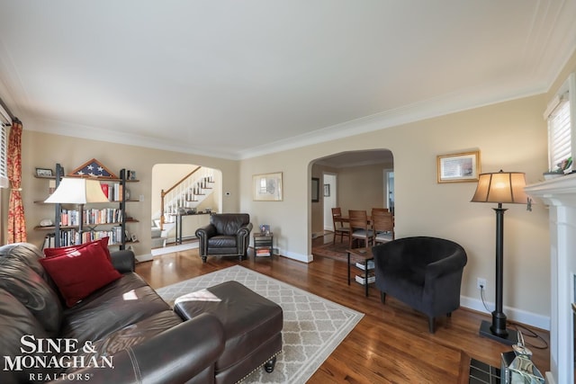 living room featuring dark wood-type flooring and crown molding