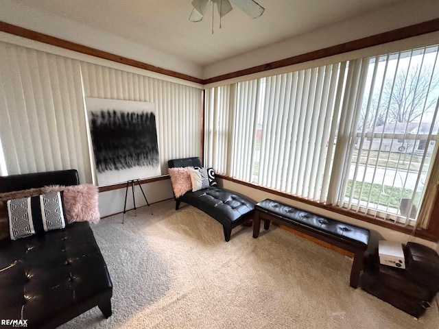 sitting room featuring carpet floors and ceiling fan